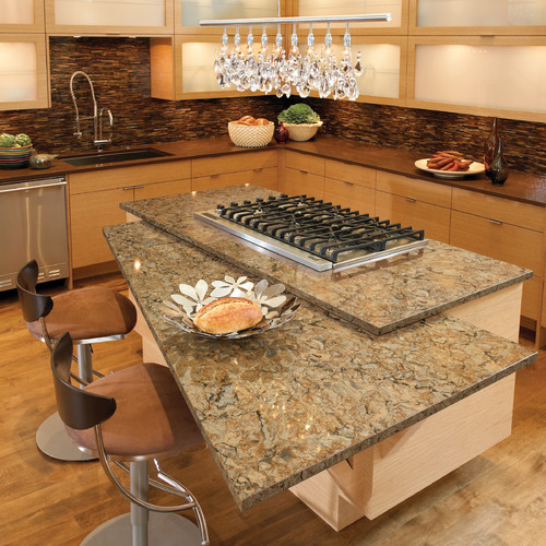 Cambria Buckingham and Cambria Oakhampton Quartz Two Tone Countertops with Two Tone Cabinets, Glass Matchstick Backsplash , Hardwood Flooring, Split Level Island Top and Kitchen Chandelier